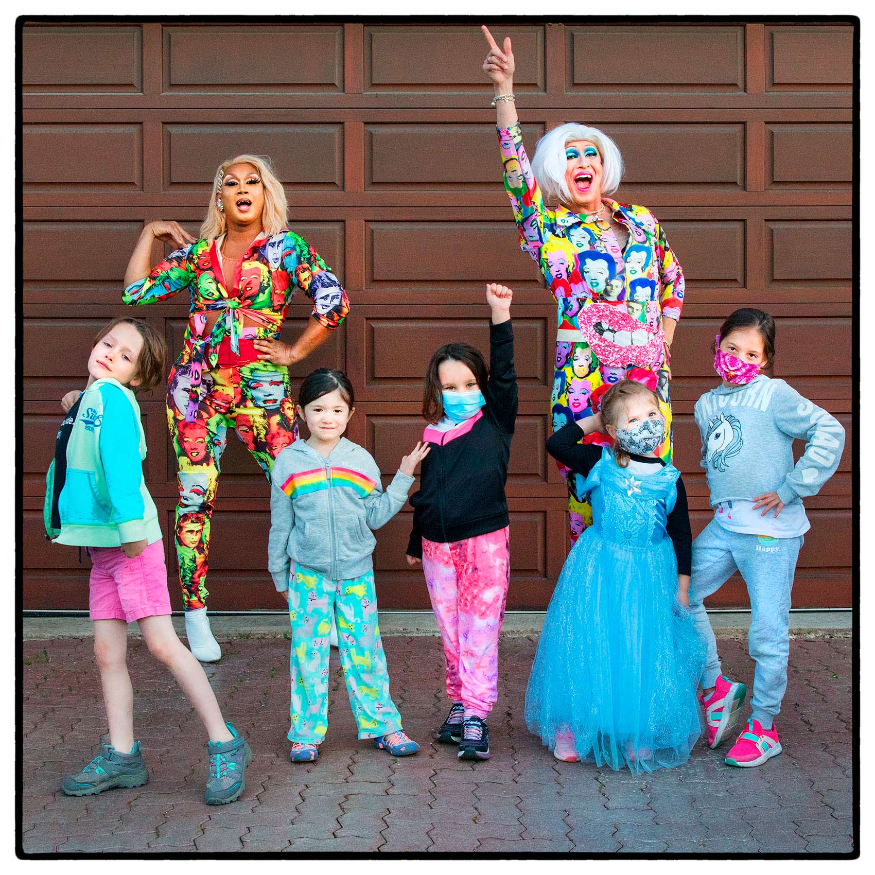  drag queens in suburban Toronto pose with children after performing in north york