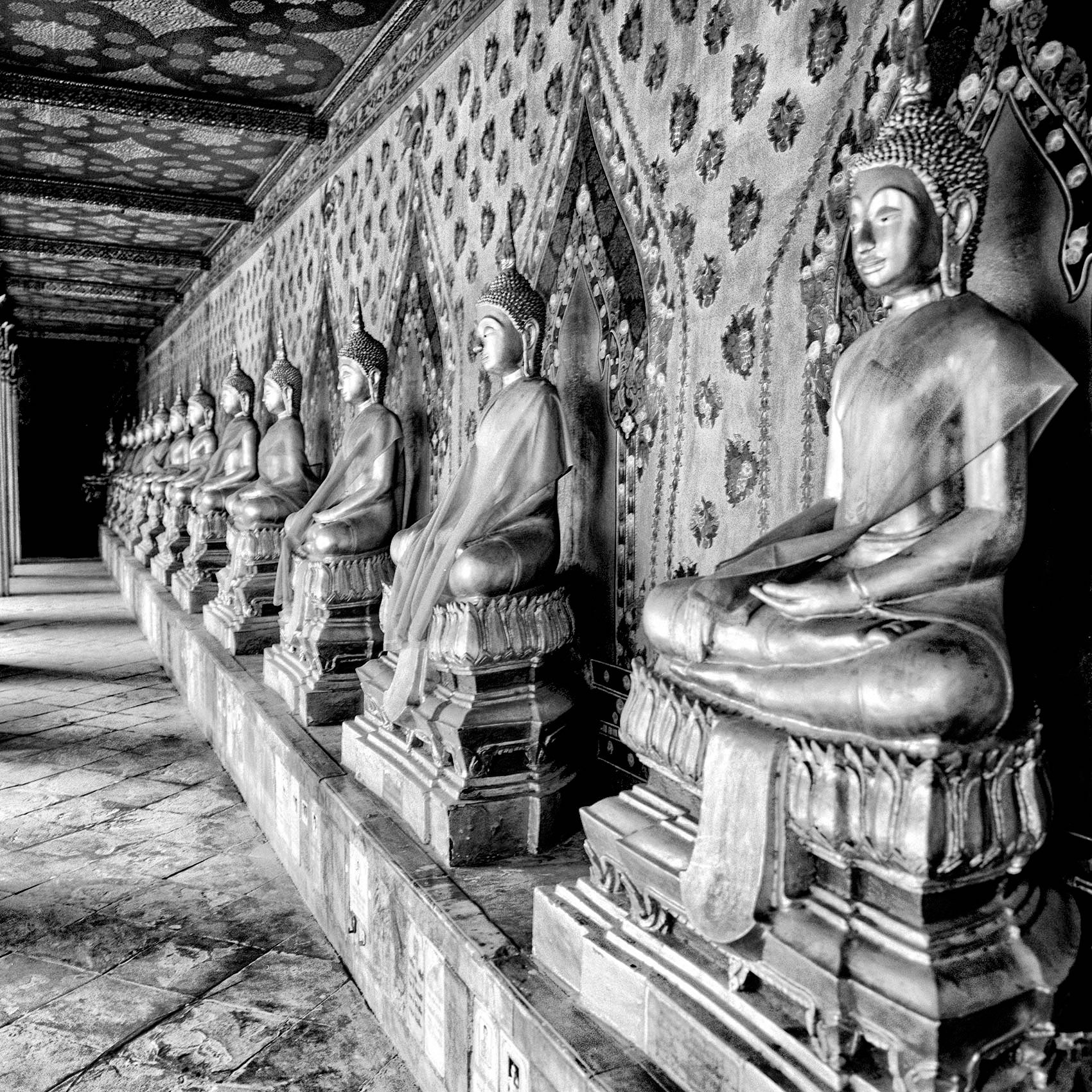 statues-of-buddha-line-up-in-a-row-at-a-temple-in-bangkok-thailand