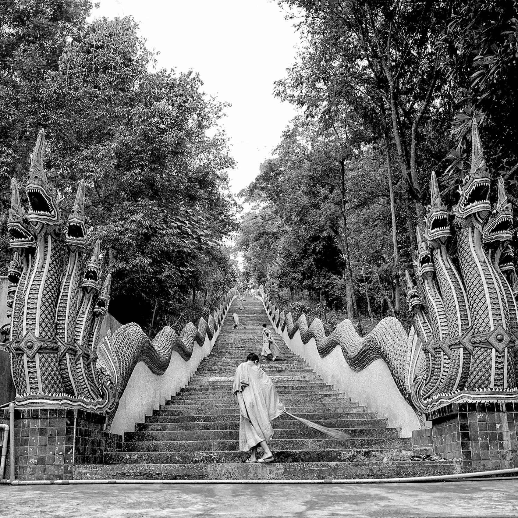 thai-monks-sweep-the-stairway-to-a-monastery-in-northern-thailand