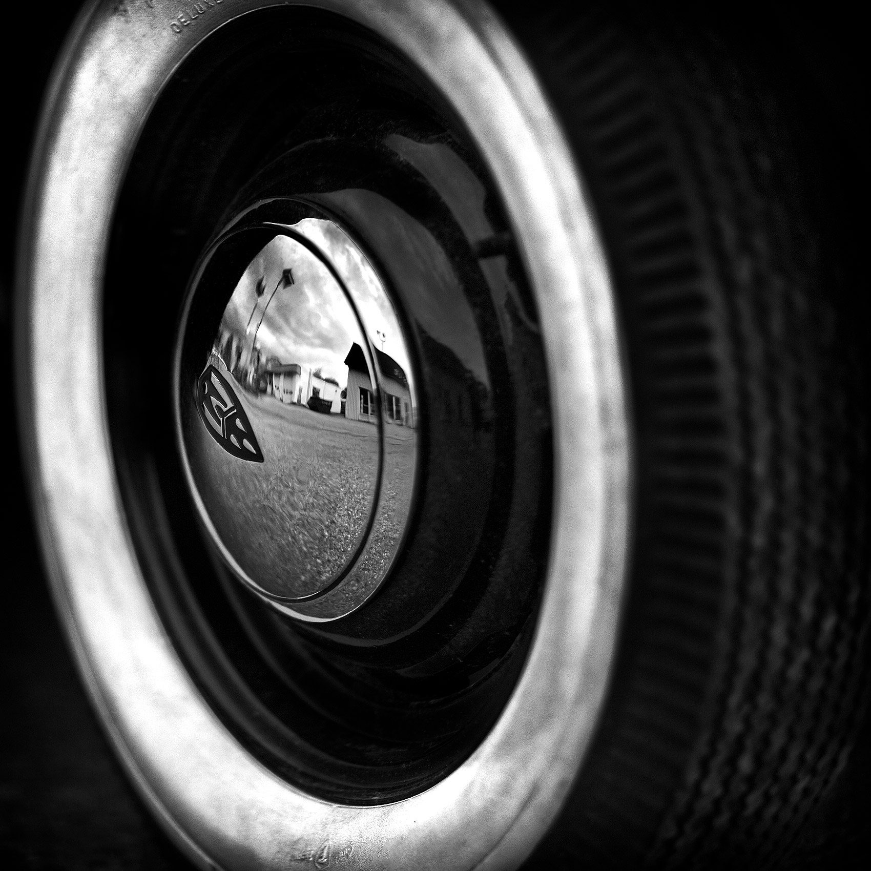 black and white photo of a tire and hubcap from an old 1946 oldsmobile in detroit michigan