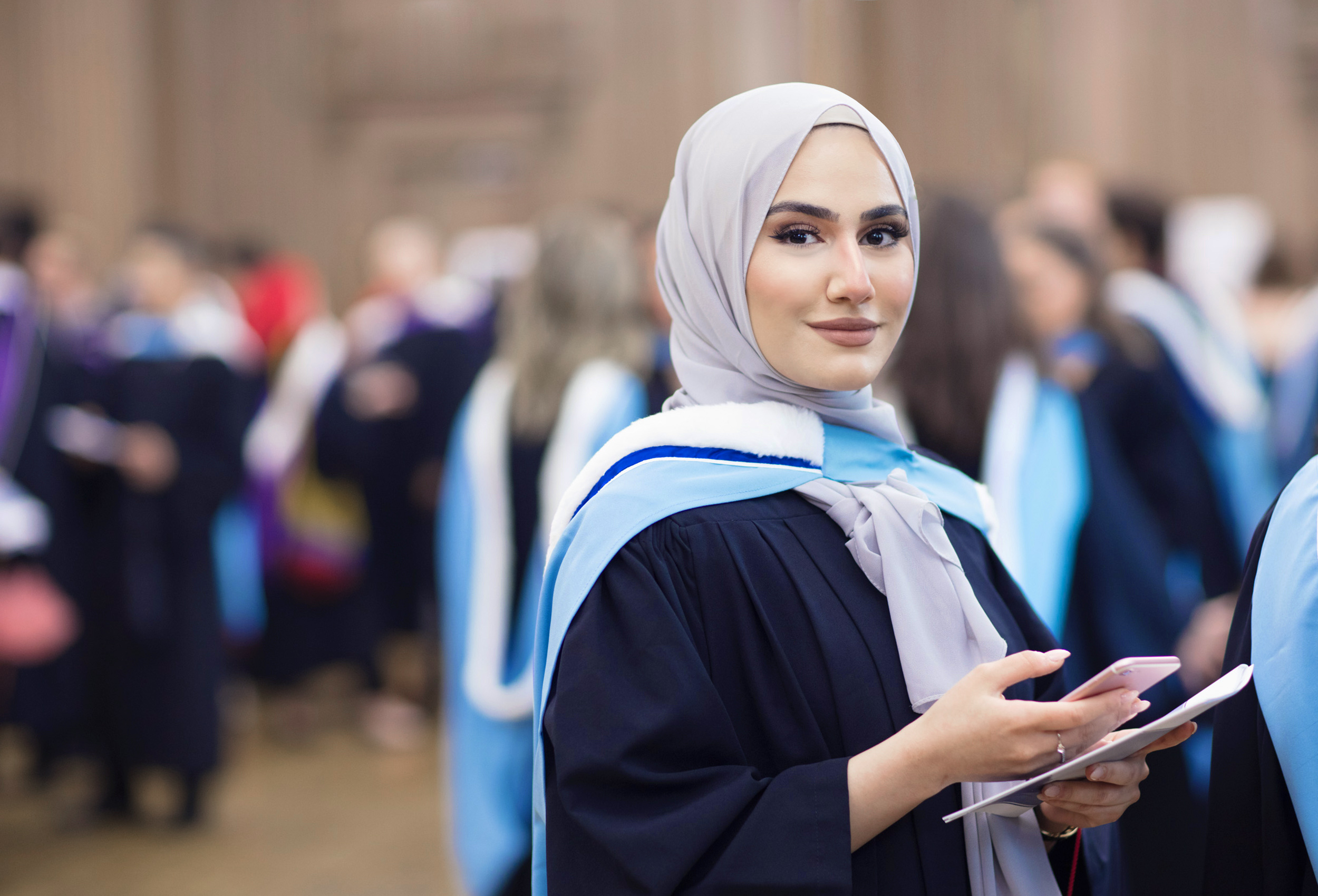 a muslim university kinesiology student smiling on her graduation day at the university of toronto