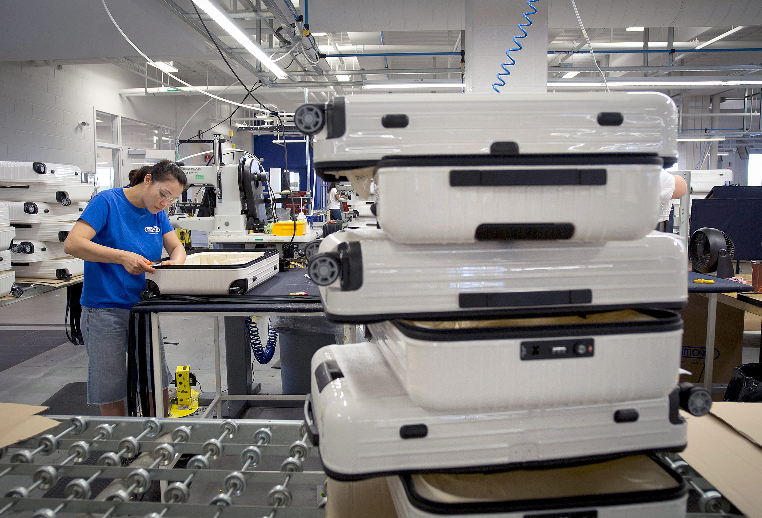 works on the rimowa assembly line in cambridge canada assemble suitcases 