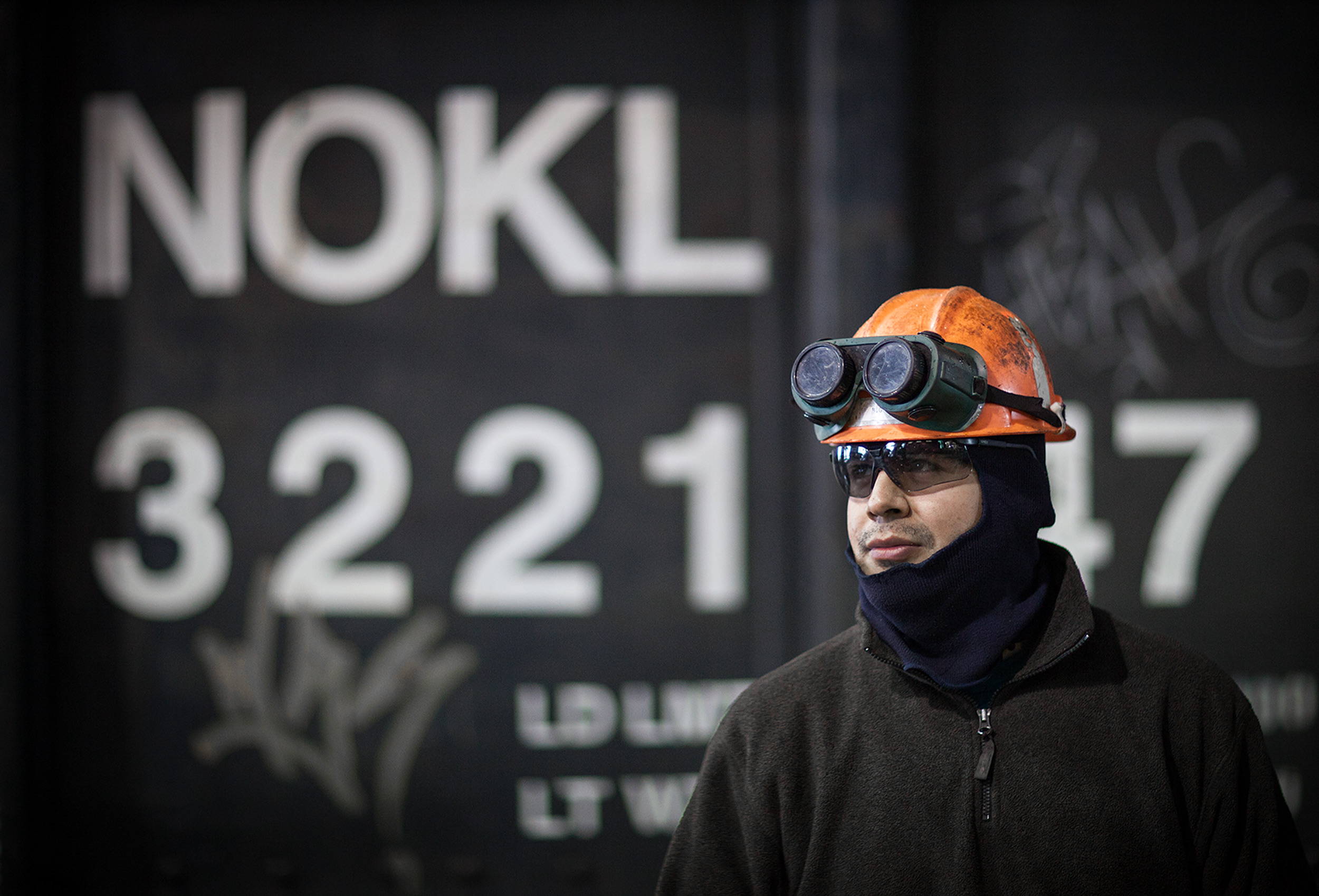 a canadian pacific employee stands in front of a freight car at their chicago rail yard
