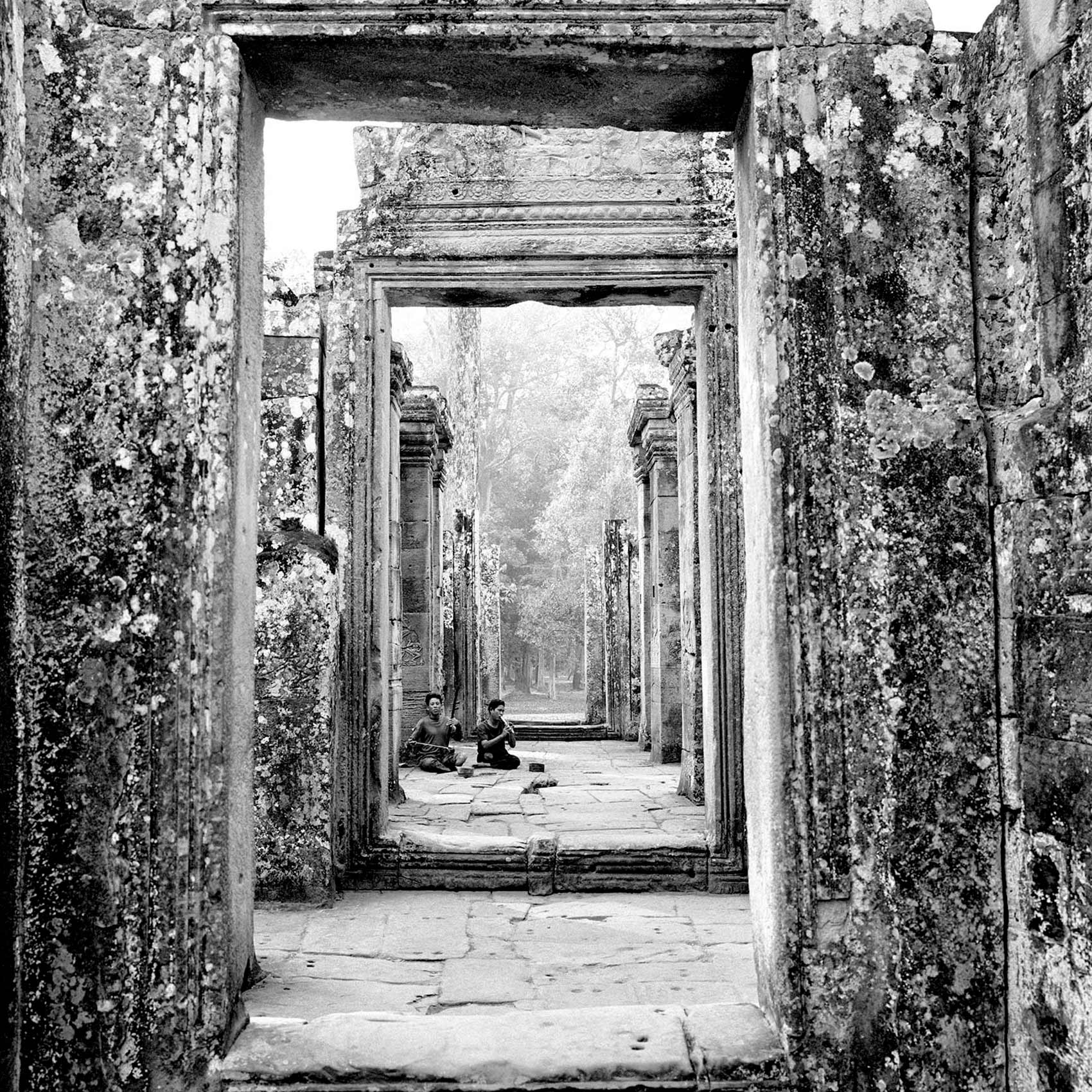 two-men-both-missing-their-legs-from-landmines-busk-inside-angkor-wat-temple-in-cambodia