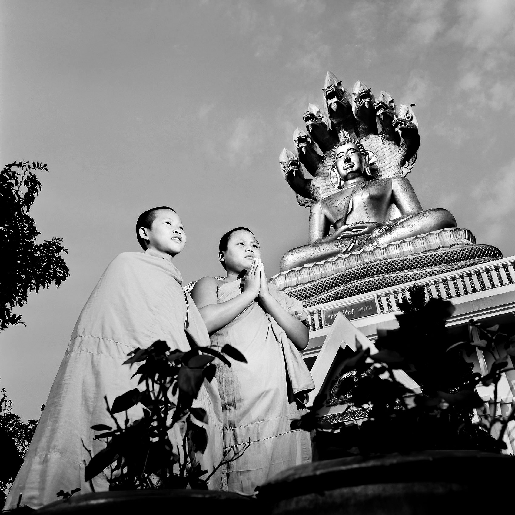 two-thai-monks-prepare-to-pray-in-the-early-morning-at-a-temple-in-chang-rai-thailand