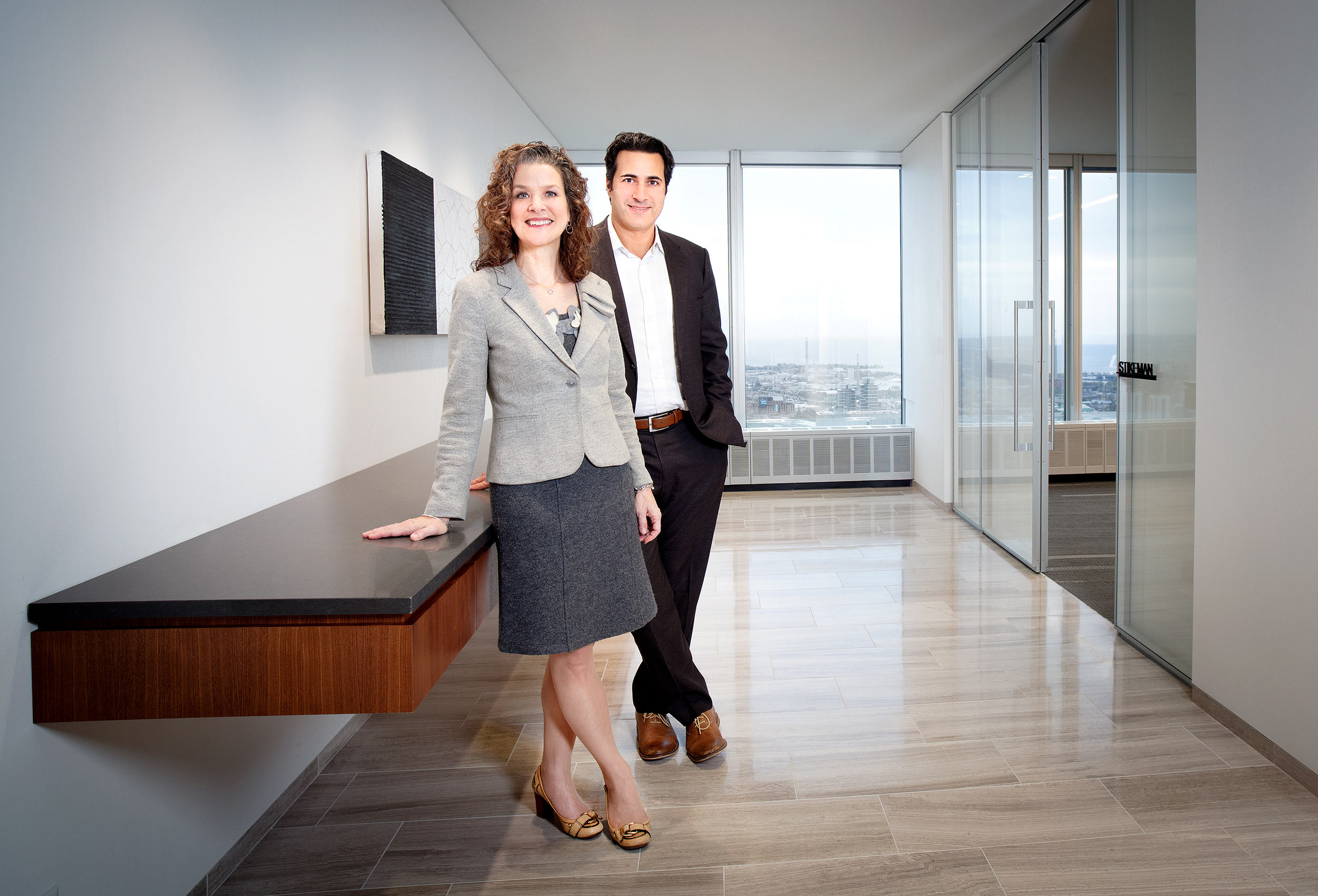 a professional corporate business portrait of two toronto lawyers at their firm.